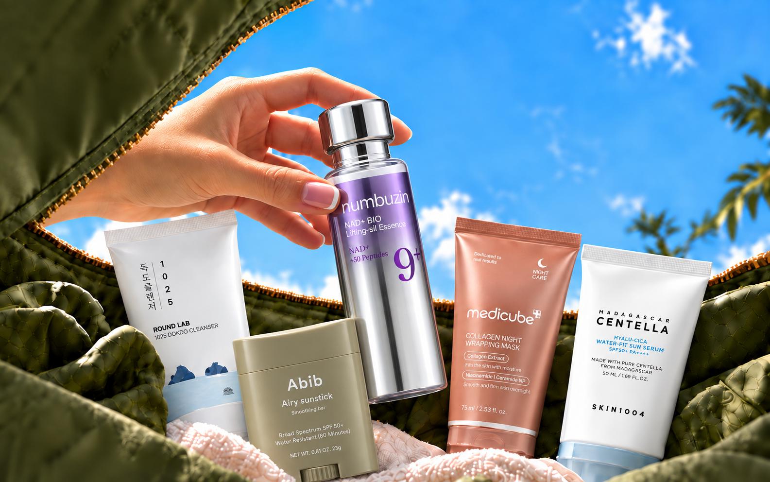 A hand holding a Numbuzin serum above Studio Hana's Korean skincare range